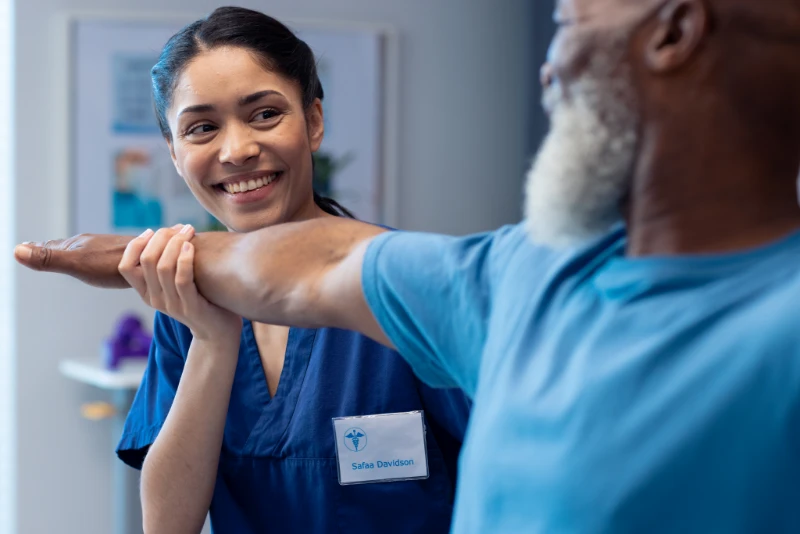 smiling diverse female physiotherapist treating ar 2023 11 27 04 58 49 utc