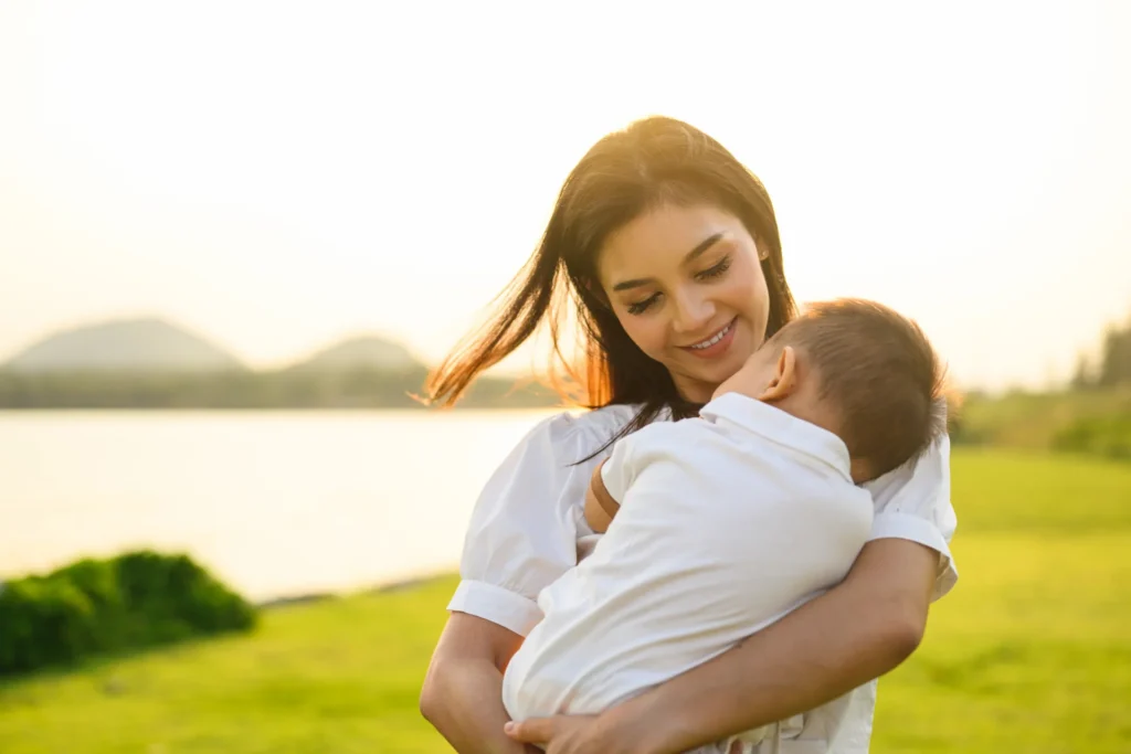 loving mother holding child in golden